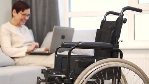 Handicapped Woman with Lapot Lay on Couch