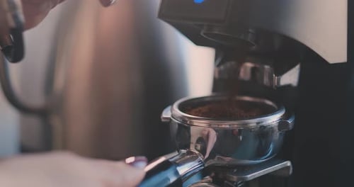 Espresso Machine Dispenses Coffee Grounds into Filter