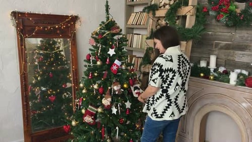 Woman Decorates Christmas Tree in Cozy Home