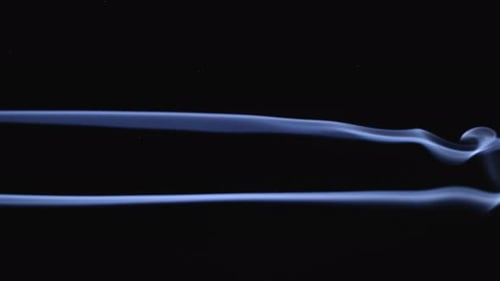 Abstract Smoke Trails Emerge on Black Background