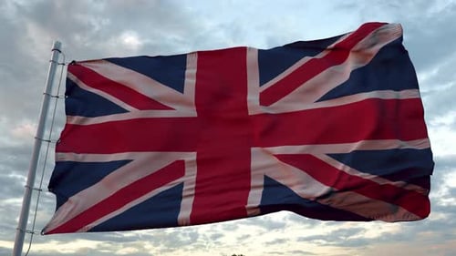 United Kingdom Flag Waving Dynamically Against a Cloudy Sky
