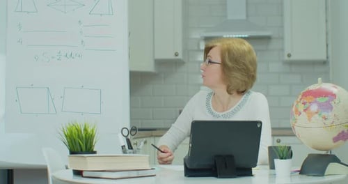 Woman Teaching Online Lesson at Home on Tablet