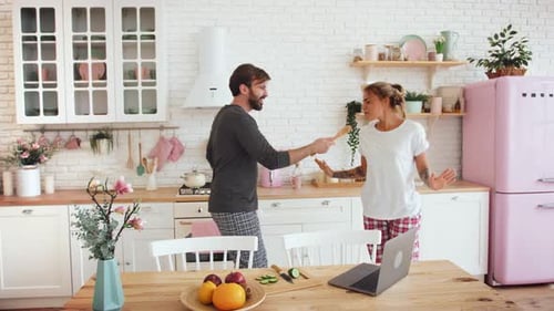 Happy Couple Dancing and Singing in Kitchen