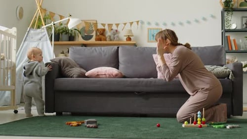 Mother and Toddler Play Peek-a-Boo at Home