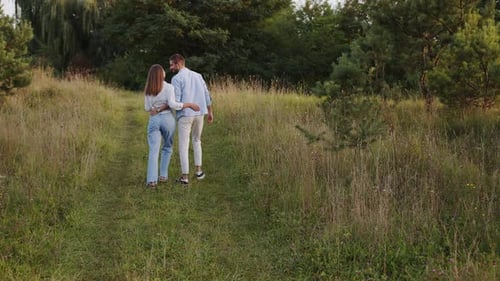 Back View of Omantic Couple Walking in Park