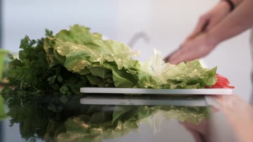 Woman Prepares Vegetables in a Bright Kitchen
