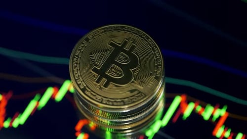 Gold Bitcoins Stacked Against Abstract Background