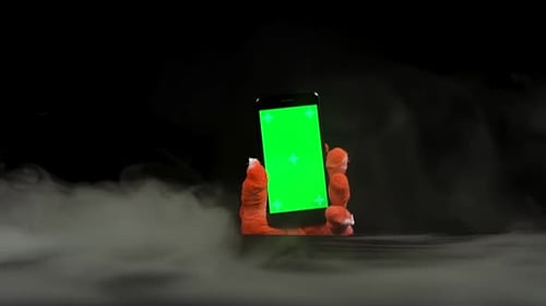 Orange Cloth Hand Holding Chroma Key Smartphone