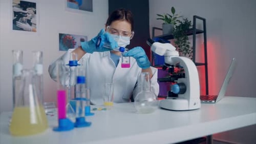Scientist Works with Pink Liquid in Laboratory