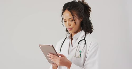 Female Doctor Using Tablet Device in Hospital
