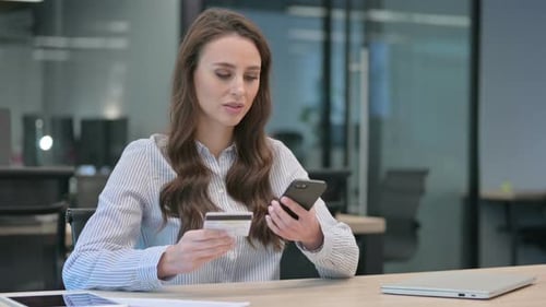 Woman Shopping Online Using Credit Card on Phone
