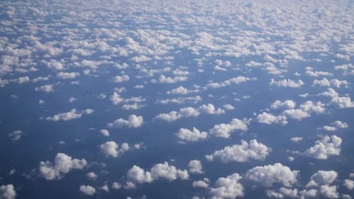Airplane View. Nice small cirrocumulus clouds pattern from above and immense blue Atlantic ocean und
