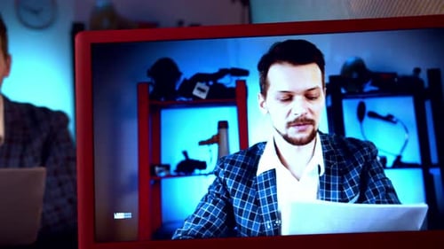 Blogger is Broadcasting in Video Studio with Cameras and Professional Lighting