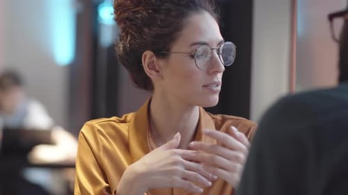 Caucasian Woman Telling Black Boyfriend about Work Problems in Cafe