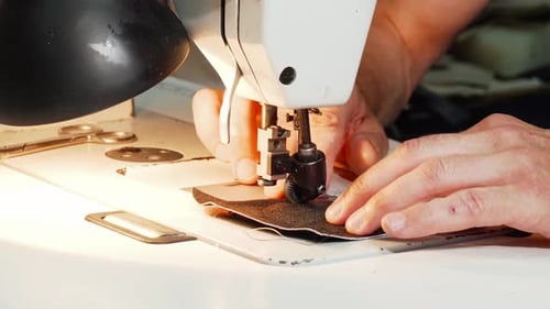 Shoemaker Using Vintage Sewing Machine at His Workshop
