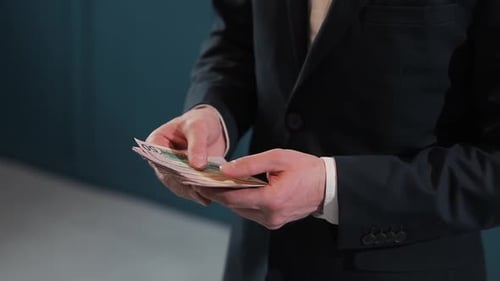 Businessman Counting Dollar Banknotes Close Up