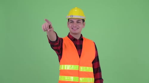 Smiling Construction Worker Pointing on Green Screen