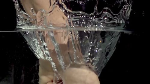 Fist Impact Creates Water Splash in Slow Motion