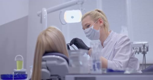 Dentist Performing Procedure on Patient in Clinic