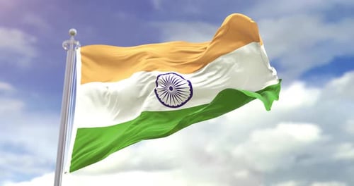 Waving India Flag Against a Blue Sky with Clouds