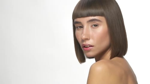 Woman with Brown Hair Turns Toward Camera