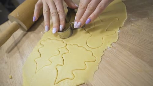 Hands Cut Gingerbread Man From Cookie Dough