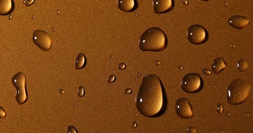 Abstract water drops on gold bronze background, macro