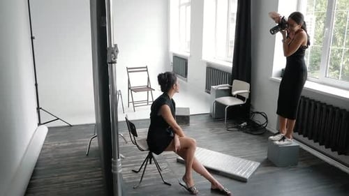 Model Posing for Fashion Photographer in Studio