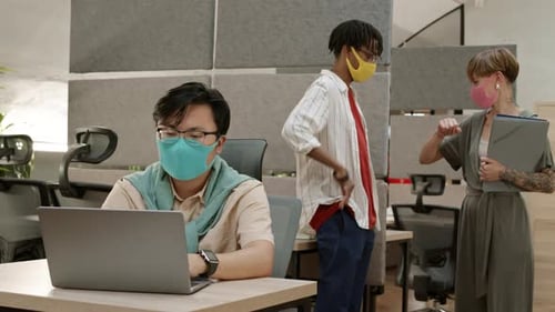 People Working in a Modern Office Wearing Masks