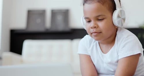 Afro American Kid Girl School Pupil Wearing Headphones Studying Online From Home Watching Web Class