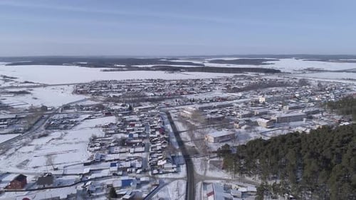 Aerial view of village with forest, fields and roads