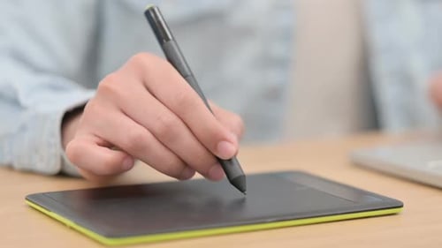 Hand Using a Graphics Tablet for Drawing