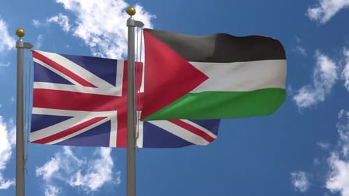 United Kingdom and Palestine Flags Waving Against Blue Sky