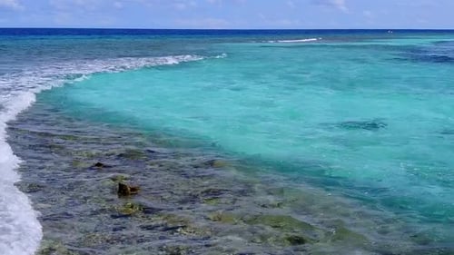 Summer travel of marine seashore beach by blue ocean with sand background near waves