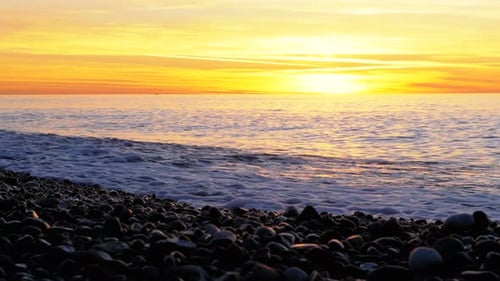 Beautiful Sunset Over the Sea Near the Rocky Shore
