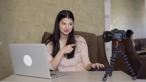 Woman Recording Vlog with Laptop and Camera at Home