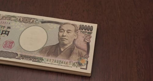 Stack of Japanese Yen on Wood Table