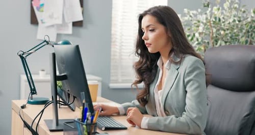Pretty Hardworking Secretary of Company Assistant to Boss Manager Sits at Desk in Office in Front of