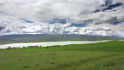 Grüne Wiesen und Felder rund um den See