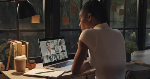 Woman Attends Virtual Meeting at Home Office