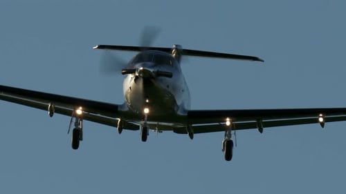 Silver Airplane Approaching to Land on Sunny Day