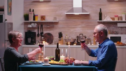 Senior Couple Shares Romantic Candlelit Dinner at Home