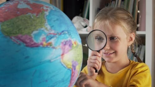 Girl Studies Globe with Magnifying Glass
