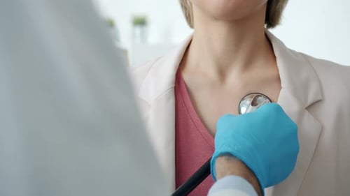 Doctor Examines Patient with Stethoscope in Clinic
