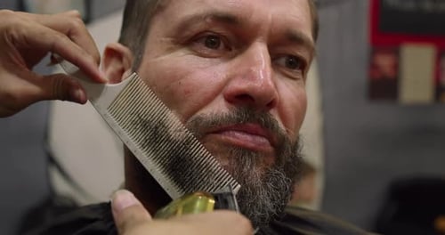 Man Getting Beard Trimmed at Barbershop