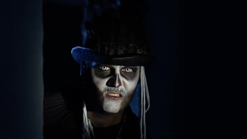 Sinister Man with Halloween Skeleton Makeup Quickly Appears From Dark Corner, Trying To Scare