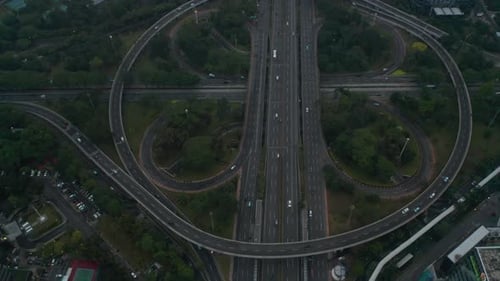 Aerial Dolly Tilt Shot Flying Over Busy Multi Lane Intersection Full of Vehicles in Modern City