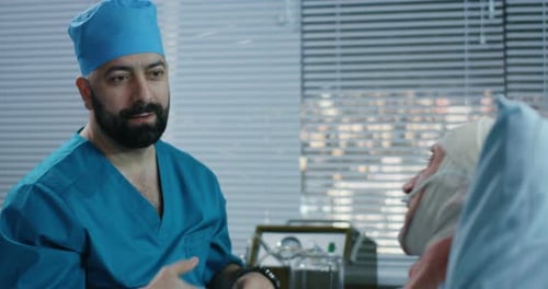 Attentive Doctor Examining Patient in Hospital Room