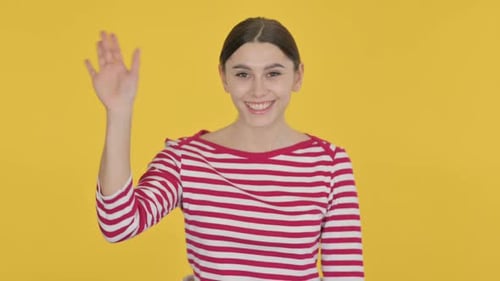 Spanish Woman Waving, Welcoming on Yellow Background