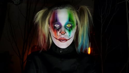 Scary Clown with Colorful Makeup in Dark Setting